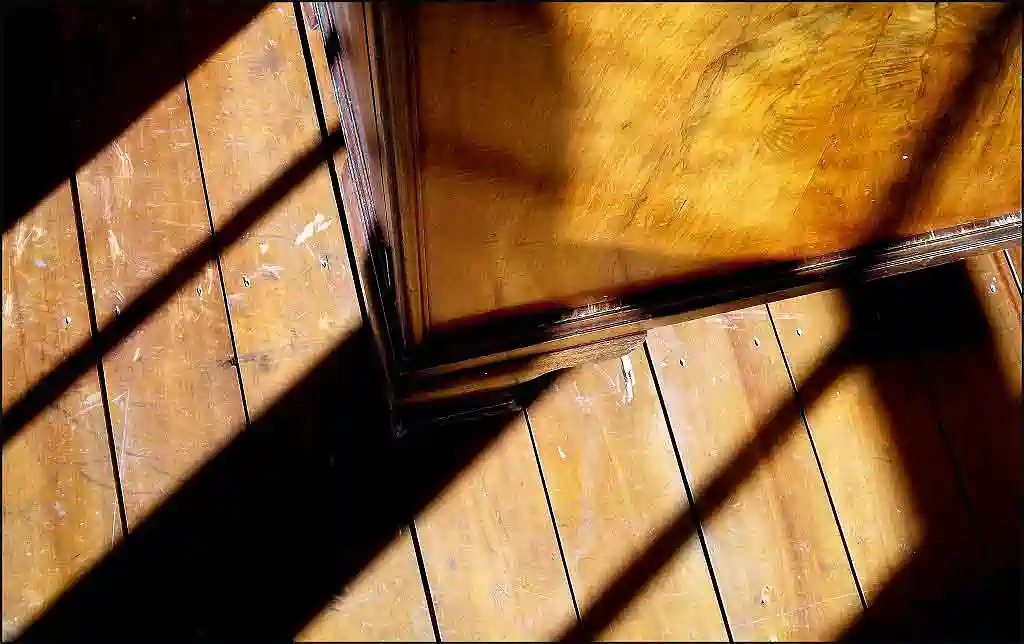 black shadows on golden coloured wardrobe and floorboards
